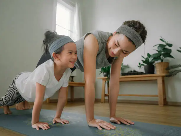 Photo of Mother and daughter doing yoga