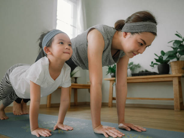 istock Young mother and daughter making a exercises at home. 1221256352