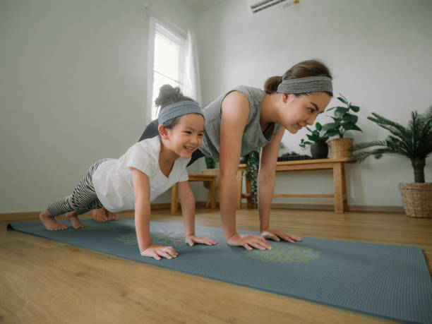 istock Young mother and daughter making a exercises at home. 1221256364