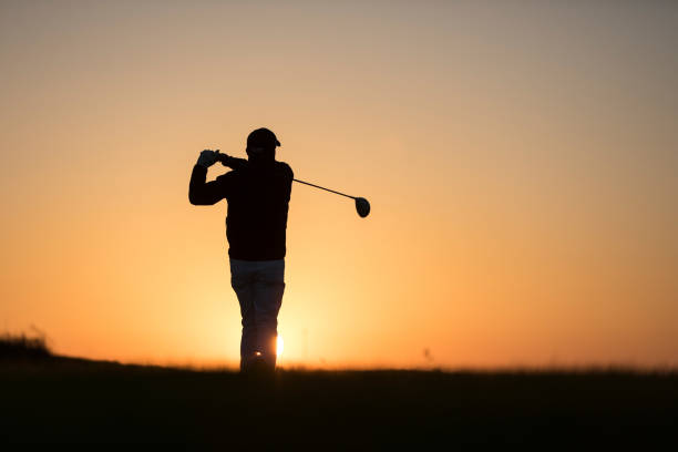 istock Golf player shoting ball at sunset time - Links golf player 1221256384