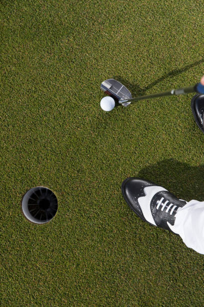 istock Golfer teeing off the ball - ready for putt - links golf 1221259541