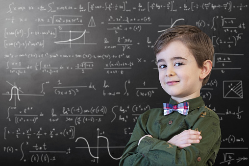 Little Boy Mathematics Formula on Chalkboard