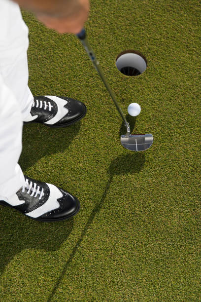 istock Golfer teeing off the ball - ready for putt - links golf 1221260005