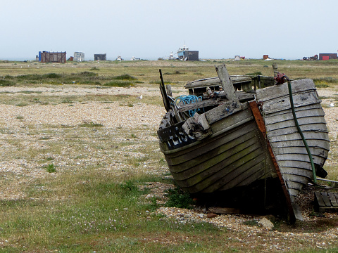 Clinker build small fishing boat that needs a bit of TLC on Dungeness beach, Kent, England