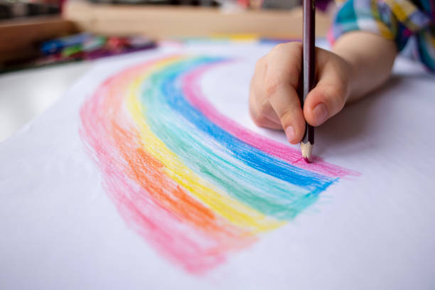 istock Child at home draws a rainbow 1221261612