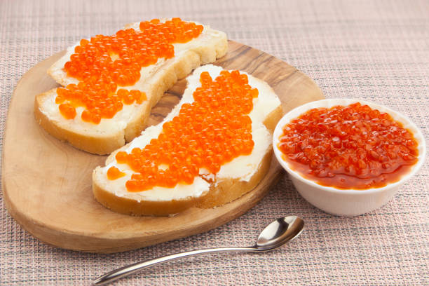istock delicious appetizing sandwich with red caviar on  wooden 1221261732