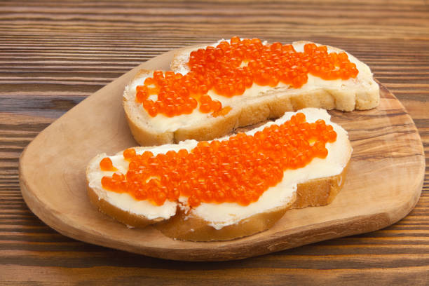 istock delicious appetizing sandwich with red caviar on  wooden 1221261735
