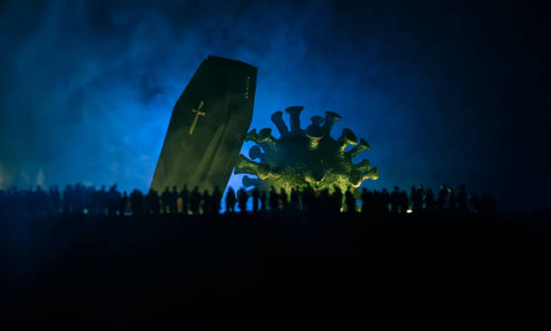 istock Coronavirus 2019-nCov novel coronavirus concept. Crowd looking on big Corona virus model at night with fog and backlight. Creative artwork decoration. Selective focus. 1221263139