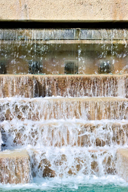 Close up. Water falling off the big stone stairs. Created in San Antonio, TX, 03/18/2019