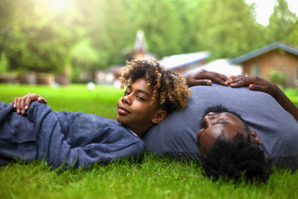 istock African-American son lays on fathers chest at backyard 1221265632