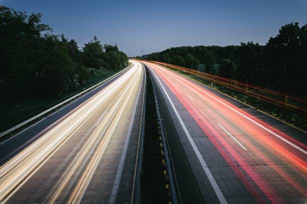istock Long exposure of highway through forest 1221267547