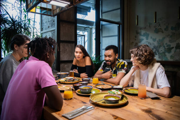 istock Young multi-ethnic friends celebrating something in a cafe 1221270169