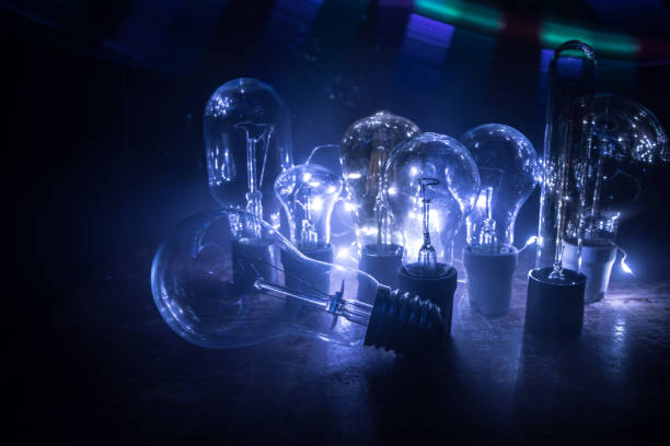 istock Abstract dark background with creative artwork decoration of glowing bulbs. 1221270208