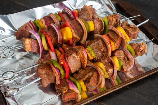 Marinated steak and vegetable kabobs on foil