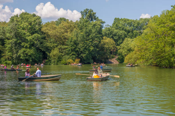 New York / NY, USA - July 24, 2019: The second largest man-made body of water in the Park, the Lake provides wonderful opportunities for viewing its abundant flora and fauna from rowboats, which are available for rent during the spring and summer months at the Loeb Boathouse.