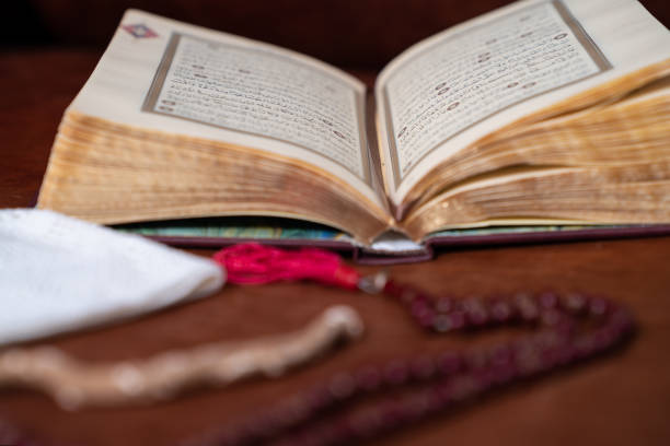 istock Holy Quran, Skull Cap And Prayer Beads On Brown Leather Background 1221271887
