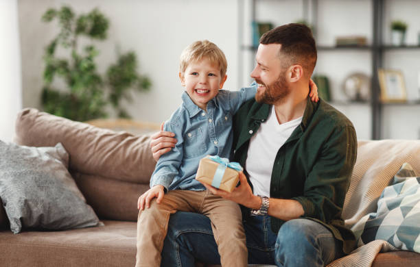 istock happy  son congratulates dad for father's day! 1221272912