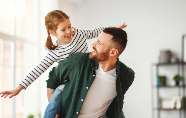 istock Father and little daughter having fun at home 1221273440