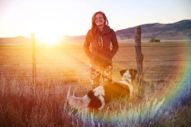 istock Young Hippie woman outdoors with pet dog 1221273594