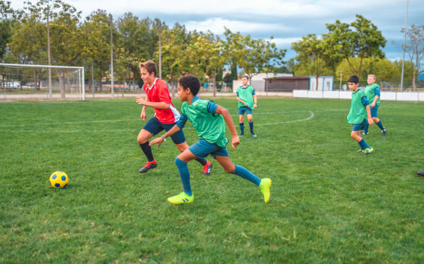 istock Boy Footballers Running for Ball During Practice Match 1221277990