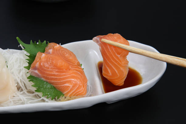 istock I lift salmon sashimi with chopsticks 1221280996