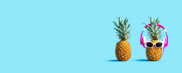 istock Pineapple wearing headphones with regular pineapple 1221282289