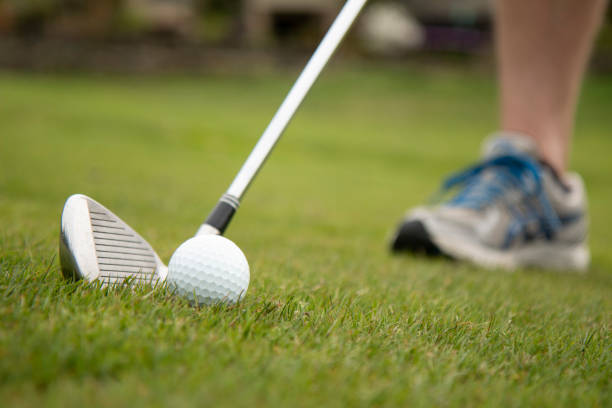 istock Getting ready to hit white golf ball on fairway with iron club 1221282833