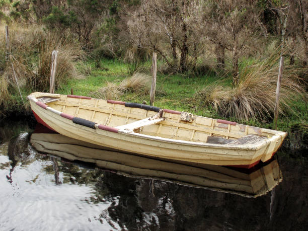 istock Old timber dinghy tied up at a small inlet in Strahan Harbour 1221283751