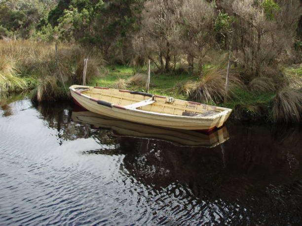 istock Old timber dinghy tied up at a small inlet in Strahan Harbour 1221283761