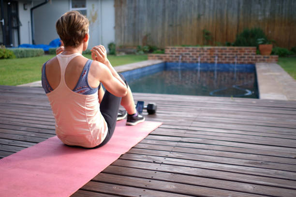 istock Women exercising outdoors with friend via teleconferencing using mobile phone 1221284542