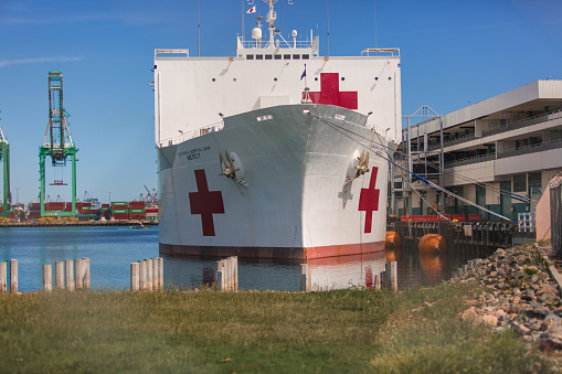 Los Angeles CA: 4/26/2020 - The USNS Mercy (T-AH-19) at the port of Los Angeles in San Pedro CA. USNS Mercy (T-AH-19) is the lead ship of her class of hospital ships in non-commissioned service with the United States Navy. Her sister ship is USNS Comfort (T-AH-20). She is the third US Navy ship to be named for the virtue mercy. In accordance with the Geneva Conventions, Mercy and her crew do not carry any offensive weapons, though defensive weapons are available. Attacking Mercy is a war crime.