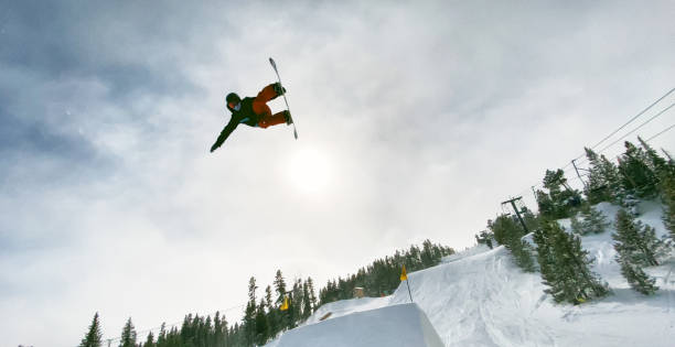 istock A Snowboarder in Full Winter Gear Attempting a Jump Trick on a Snowboarder at Eldora Ski Resort near Boulder, Colorado on a Bright, Sunny, Winter Day 1221285440