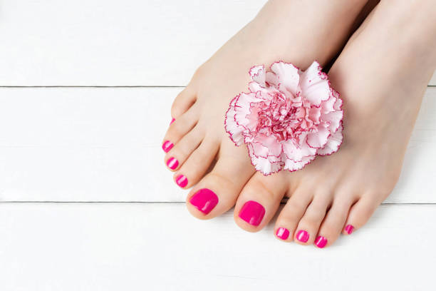 istock Pink pedicure with a flower on white wooden background, top view, copy space 1221287086