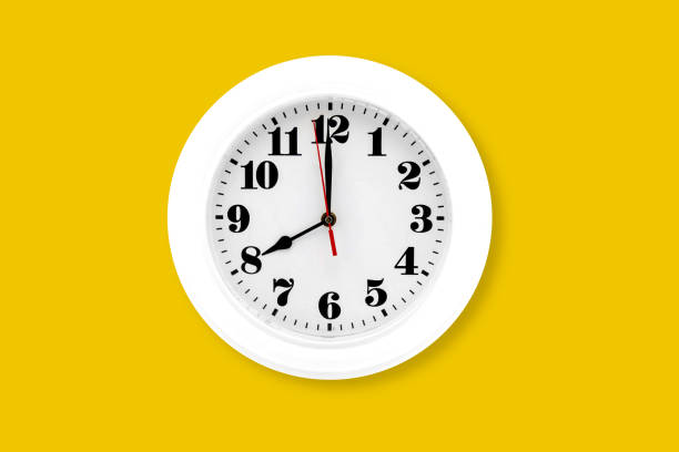 istock Modern wall clock white isolated on yellow background, time and period, office timepiece and mockup with hour and minute, hour hand, object classic. 1221289399