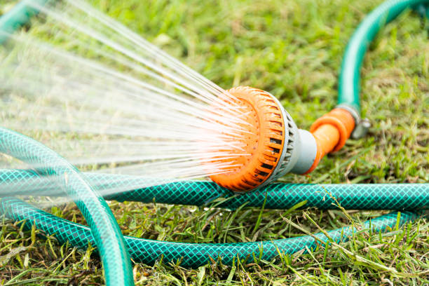 Garden green hose for lawn irrigation stock photo