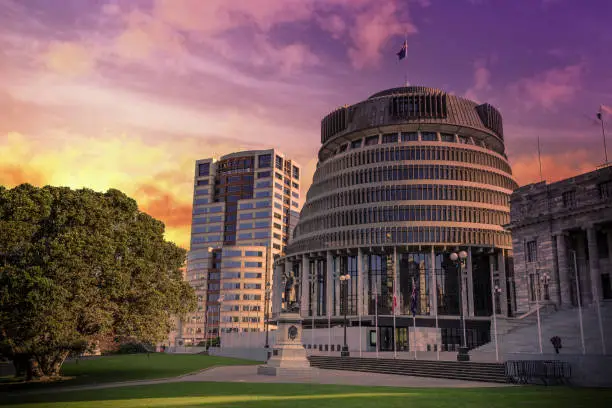 Photo of the Beehive, Wellington, New Zealand - New Zealand Parliament building under a vibrant sunset