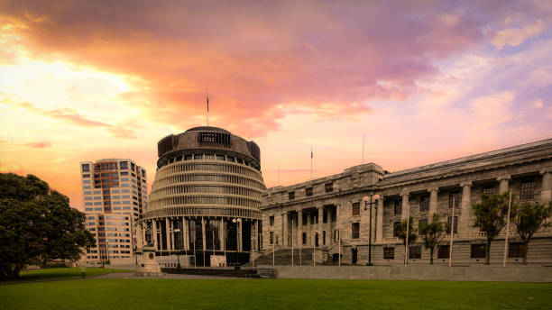 the Beehive, Wellington, New Zealand - New Zealand Parliament building under a vibrant sunset New Zealand Parliament building under a vibrant sunset beehive new zealand stock pictures, royalty-free photos & images