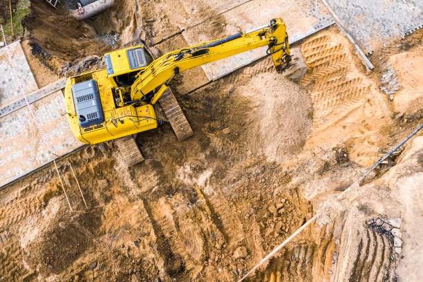 istock yellow excavator working on a construction site. aerial view 1221293499