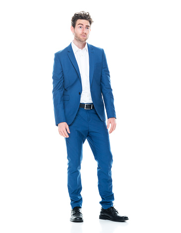 Full length of aged 30-39 years old with brown hair caucasian young male business person standing in front of white background wearing businesswear who is bored