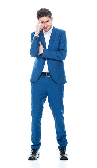 Full length of aged 30-39 years old with brown hair caucasian young male business person standing in front of white background wearing jacket who is horror