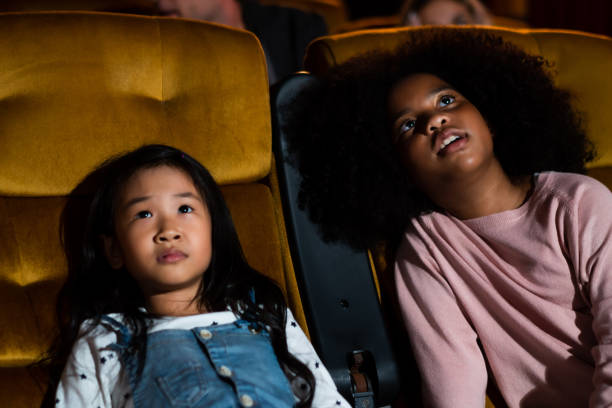 istock Two children having fun and enjoy watching movie 1221296470