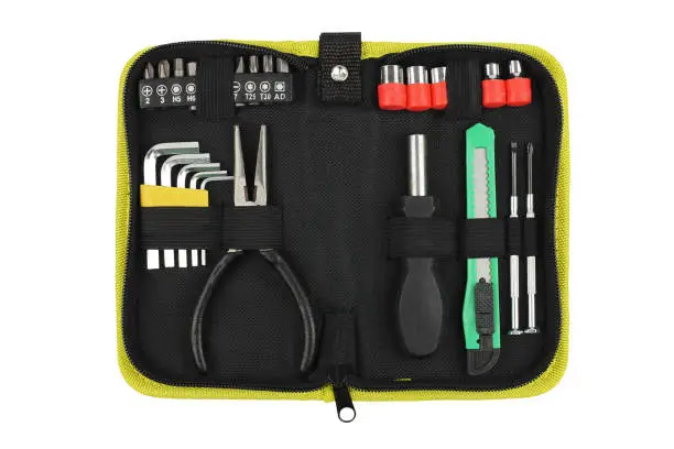 portable or pocket toolkit with set locksmith tools for home, pliers, hexagon keys, screwdriver, top view closeup, small equipment case isolated on white background, concept of gift for father's day