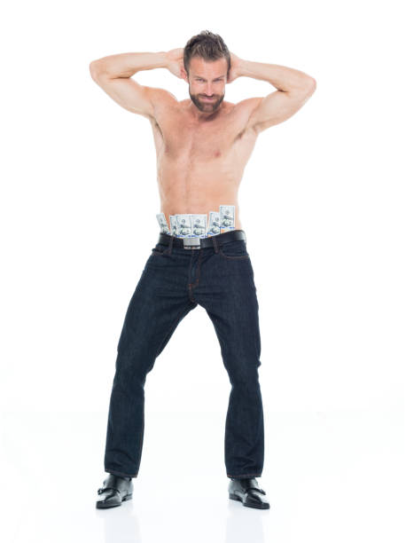 caucasian male stripper exercising in front of white background wearing jeans and holding us currency - male stripper imagens e fotografias de stock