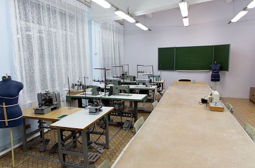Empty classroom with vintage tone wooden chairs. Classroom arrangement in social distancing concept to prevent COVID-19 pandemic. Back to school concept.
