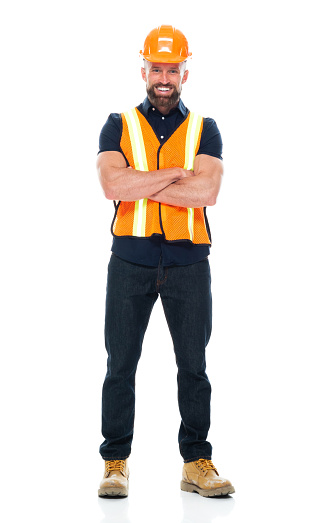 Full length of with short hair caucasian male repairman standing in front of white background wearing jeans who is successful who is working with arms crossed and holding hammer