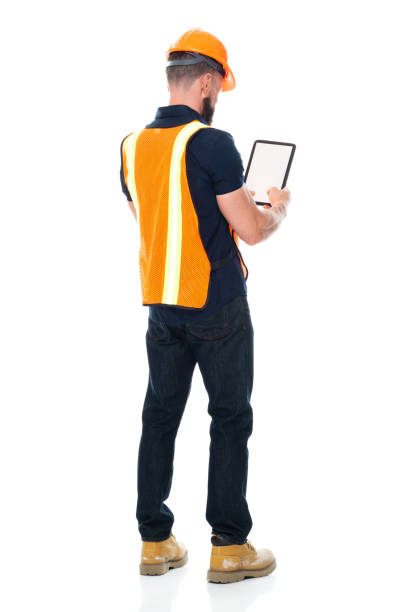 istock Technician repairing wearing pants and holding hammer and using touch screen 1221299527