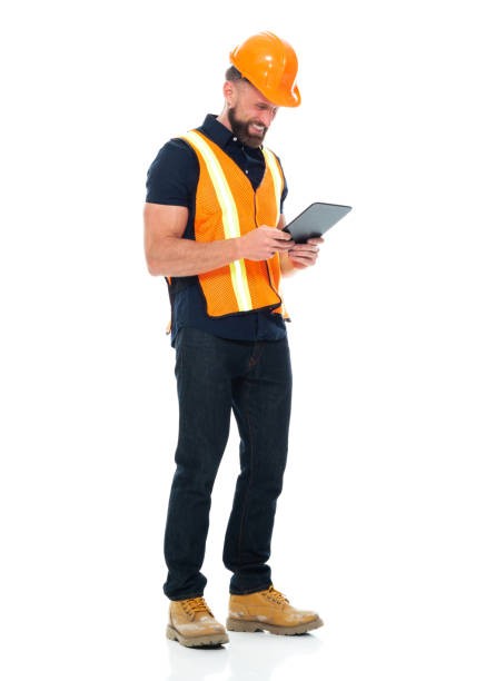istock Construction worker repairing wearing pants and holding hammer and using touch screen 1221299530