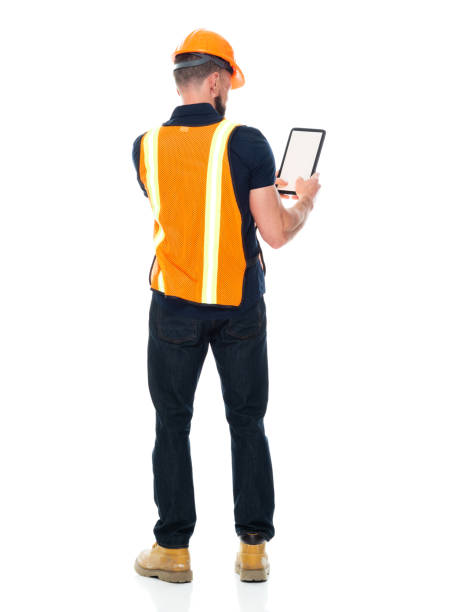 istock Repairman standing wearing shirt and holding hammer and using digital tablet 1221299562