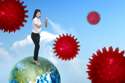 Asian businesswoman spraying disinfectant in the air. Prevent the spread flu disease Coronavirus