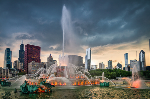 Chicago Dramatic Cloudscape Over Buckingham Fountain. Illuminated Buckingham Fountain in Grant Park and Chicago Skyline in the Background during an dramatic sunset twilight. Chicago, Illinois, USA, North America.